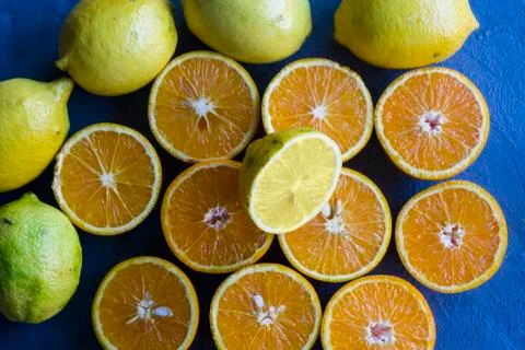 Some half oranges with a half lemon in the center and entire lemons Stock Photos