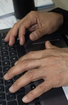 Some hands on a computer Stock Photos