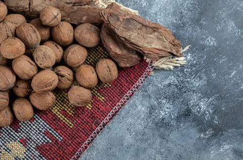 Some of healthy walnuts with tree bark on a gray background Stock Photos