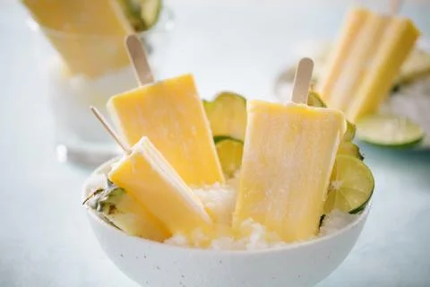 Some homemade Pineapple Popsicles (selective focus) on a rustic background Stock Photos