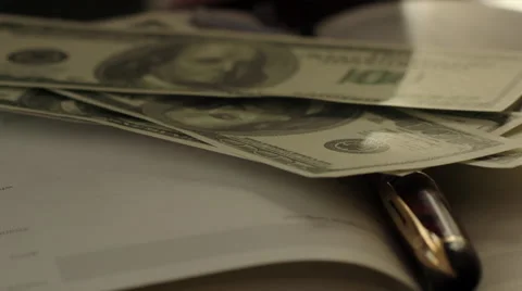 Some Hundred Dollars Banknotes on the Book Stock Footage 60350622