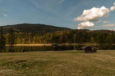 Some huts on a meadow with the Ferchensee in front Stock Photos