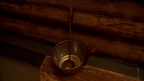 Some important sauna essentials on sauna benches water bucket with scoop Stock Footage 221942123