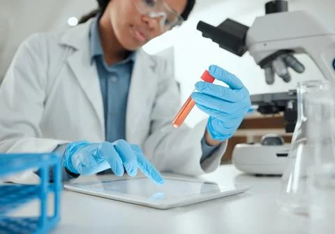Some interesting feedback has come back. a scientist holding a sample while Stock Photos