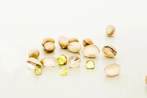 Some isolate pistachio on a white table. Stock Photos