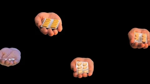 Some isolated on black background hands with pills Stock Footage 73257216