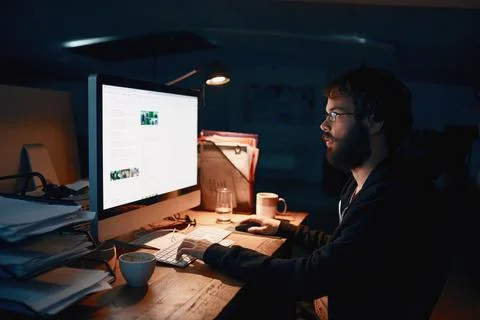Some late night programming. Cropped shot of a young computer programmer work Stock Photos