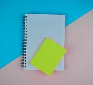 Some light green sticky notes on top of a white paper diary before a paper ba Stock Photos