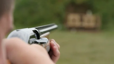 Some man aiming and shooting from a skeet shooting rifle in slow motion Stock Footage 76054408