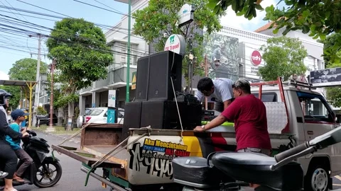 Some men are preparing the sound system on top of the pickup Stock Footage 236520265