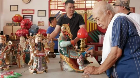 Some men clean Buddhist Gods Statues in a temple. Stock Footage 169065420