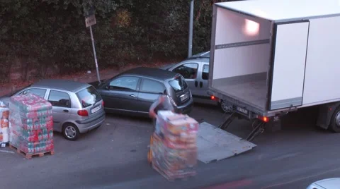 Some men load boxes on truck with pallet jack, Rome, Italy. Stock Footage 947485