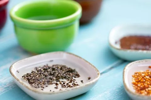 Some microgreen seed like broccoli or garlic in various pots full of water 库存照片