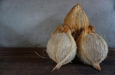 Some old coconuts that have been opened are on the trasitional chocolate table Stock Photos