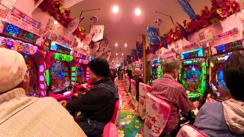 Some of the old people playing on the arcade game in Osaka Japan Stock Footage 129277065