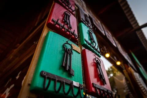 Some old rusty keys hanging on a colorful wooden key chain. Translation of sea Stock Photos
