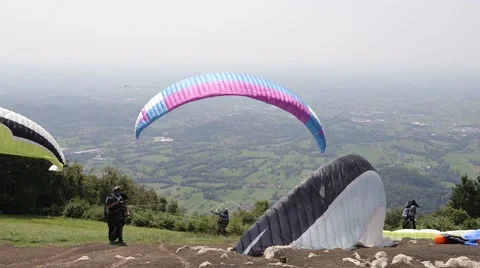 Some paragliders take-off from mountain Stock Footage 65487093