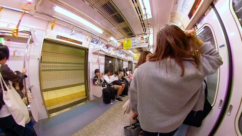 Some of the passengers near the door of the train in Osaka Japan Stock Footage 129279109