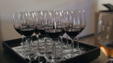Some people are holding red wine cups in a wine tasting to see the wine Stock Footage