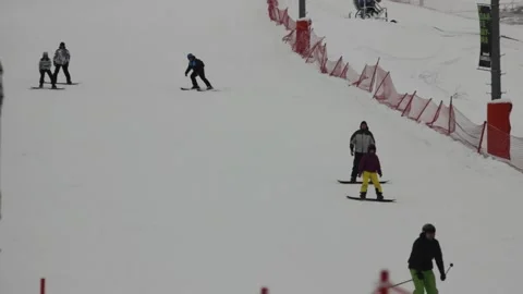 Some people are skiing down the pass at the ski resort Stock Footage 146638564