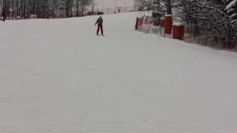 Some people are skiing down the pass at the ski resort Stock Footage 146638814