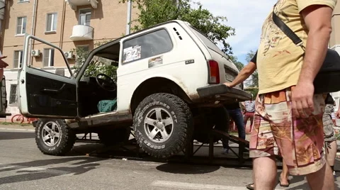Some people manually raise the car Stock Footage 64570427