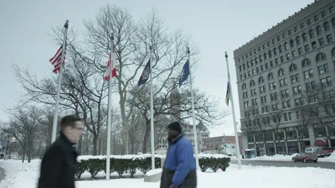 Some People Walk By Some Flags in Buffalo Stock Footage 171816669
