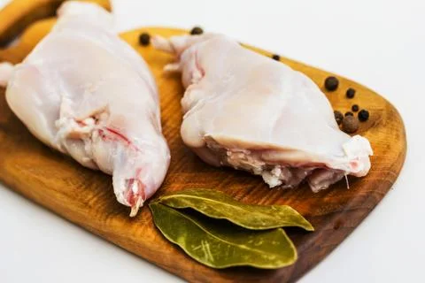 Some pieces of raw rabbit meat with vegetables and spices Stock-Fotos