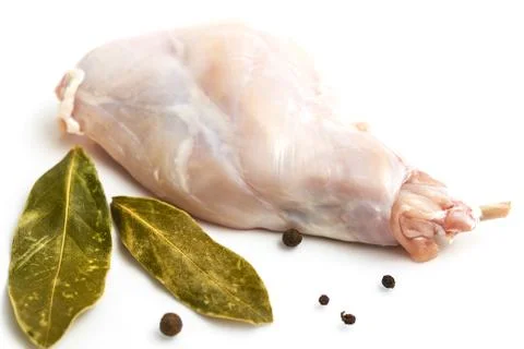 Some pieces of raw rabbit meat with vegetables and spices Stock Photos