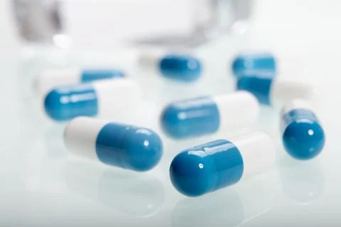 Some pills on glass table Stock Photos
