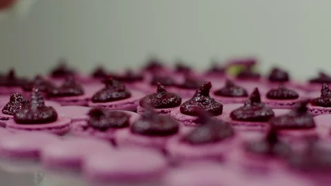 Some of pink macarons' halves coated with cream Stock Footage 72355945