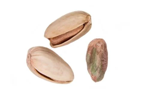 Some pistachios on a white background seen from above Stock Photos
