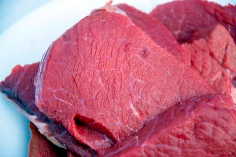 Some raw beef fillets on a plate. Close up macro. Selective focus. Stock Photos