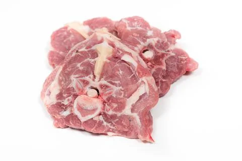 Some raw lamb neck chops on a white background Фото