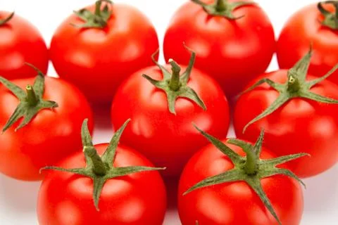 Some red tomatoes close-up on a white background Stock Photos