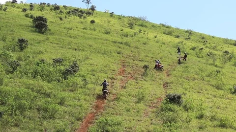Some riders on a steep hill Stock Footage 89732065