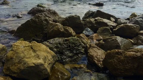 Some rocks at bay with small waves Video stock 71771113