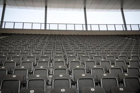 Some rows of gray stadium seats, shoot from the front Stock Photos