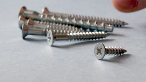 Some screws, with cross head, on grey background 스톡 동영상 175238858