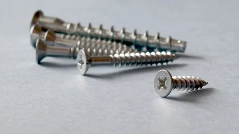 Some screws, with cross head, on grey background Stock Footage 175238923