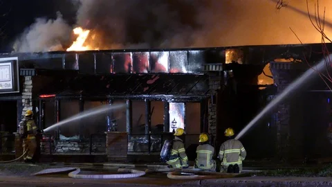 Some sit and some stand but all fight the fire in the fraternity of firemen Stock Footage 129987987