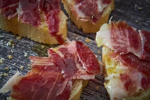 Some slices of bread with Iberian ham and olive oil Stock Photos
