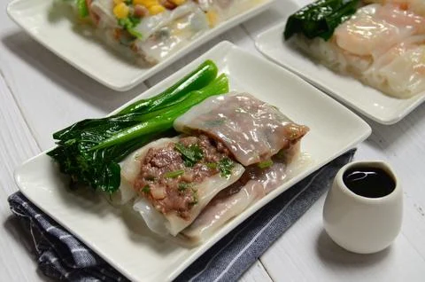 Some small plates with different types of food on them on a white table Stock Photos