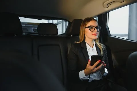 Some sort of interesting information. Smart businesswoman sits at backseat .. Stock Photos