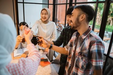 Some students in the pose of let's toast with glasses Stock Photos