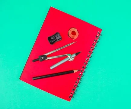 Some study material containing a pencil compass,a pencil sharpener a crayon o Stock Photos