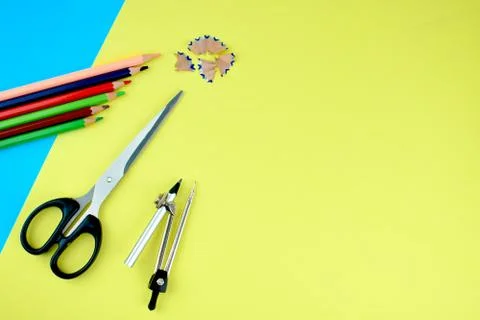 Some study materials scattered on a blue and yellow paper background while fa Stock Photos