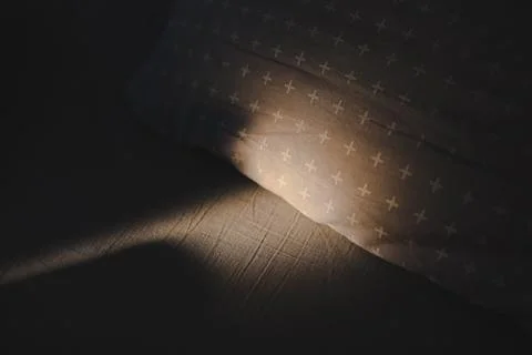 Some sunlight and shadows on bed linen . Crumpled blanket on morning bed Stock Photos