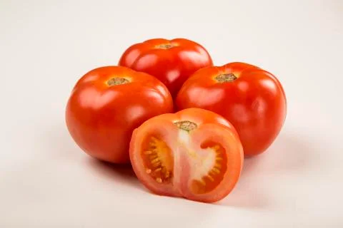 Some tomatoes over a white background Stock Photos