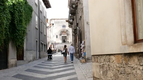 Some tourists stroll through the streets of Pescocostanzo Stock-Footage 200012524